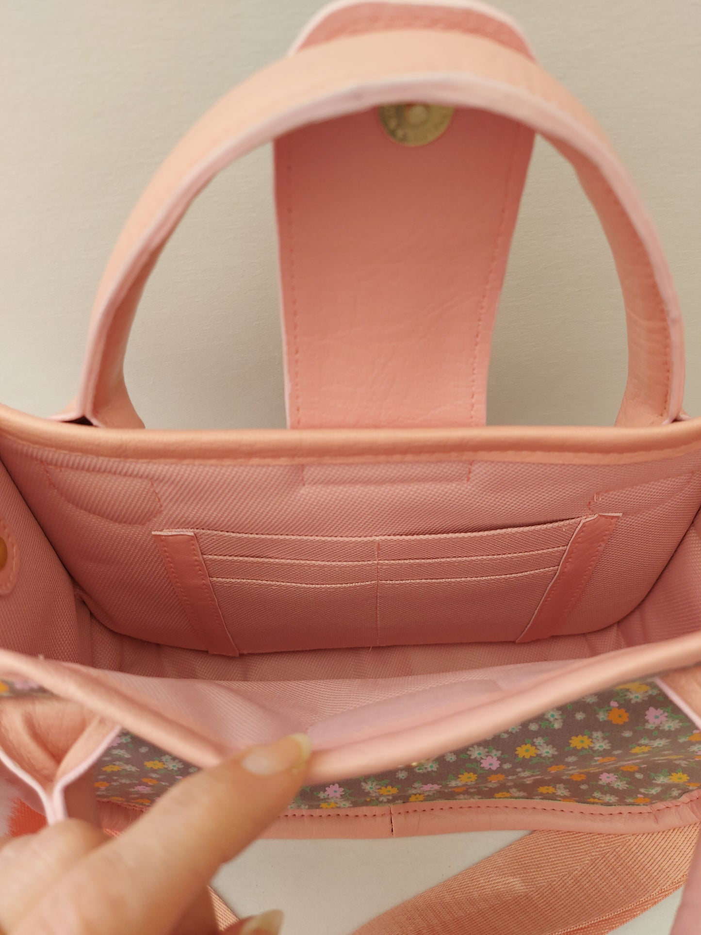 pink faux leather and floral small essentials handbag and crossbody