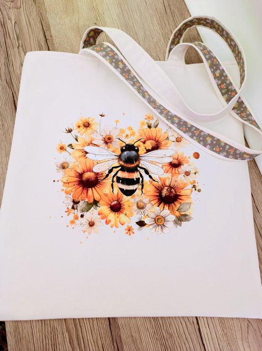 Handmade canvas tote bag with bee and flowers transfers, floral lining, sturdy shoulder straps, perfect for everyday use or gifts.